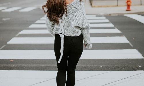 a woman standing in a crosswalk